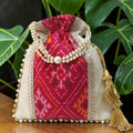 Patola Ikat & Tissue Silk Potli Bag – Dark Pink | Handcrafted with Pearl Handle & Gold Tassels