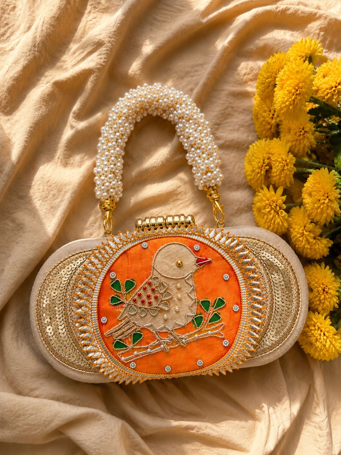 Orange Bagh-e-Bulbul embroidered clutch with pearl gajra handle, festive wedding bag