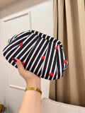 Black and white striped pleated clutch with red heart embroidery