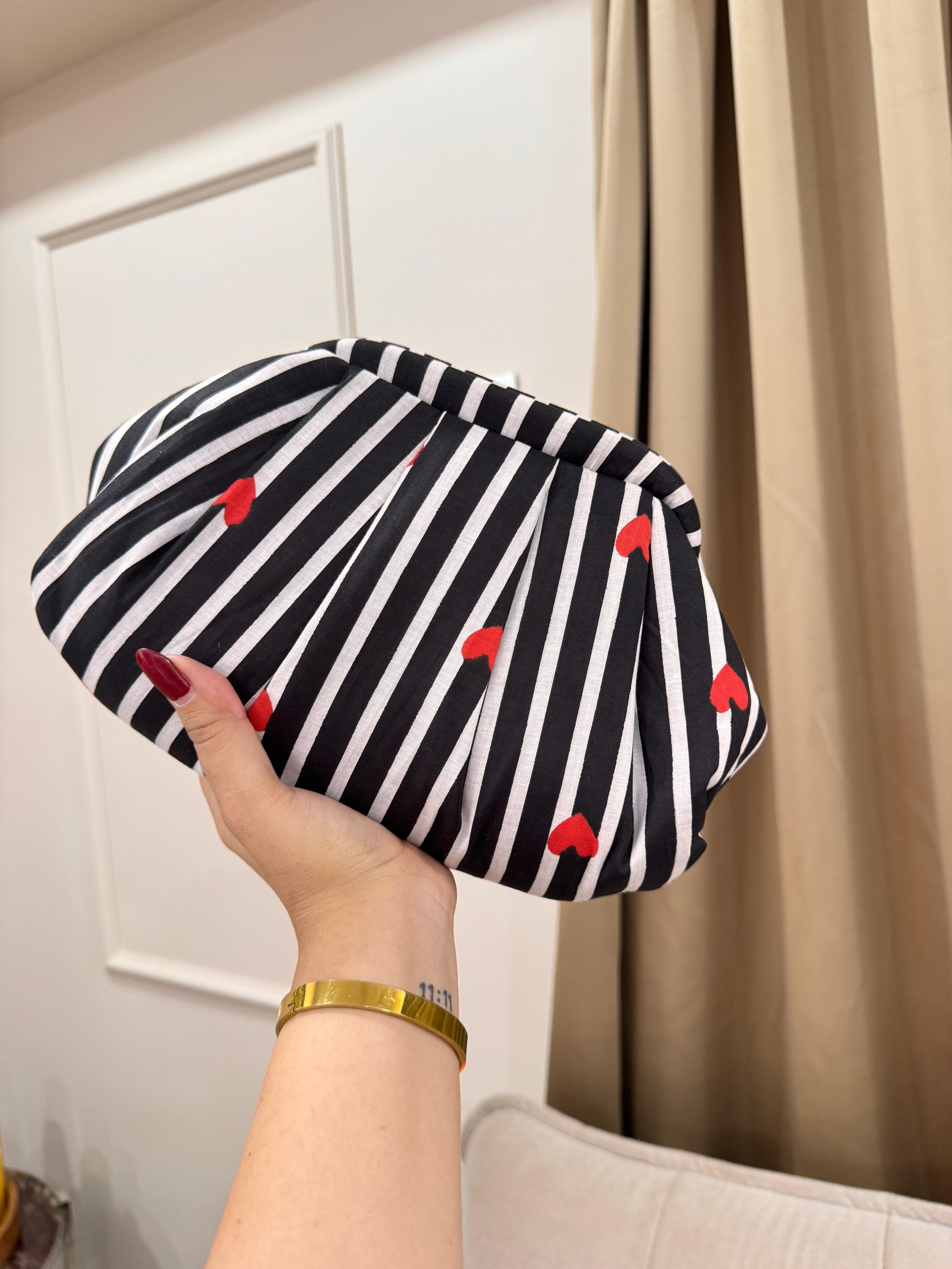 Black and white striped pleated clutch with red heart embroidery