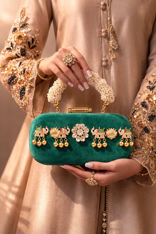 Box clutch in kundan-embellished ivory suede, angled view showing beadwork detail