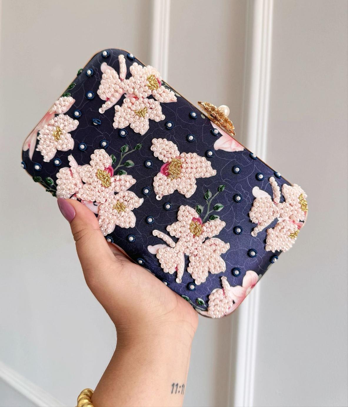 Navy pearl floral box clutch with pink beaded magnolias on deep blue satin and a gold clasp