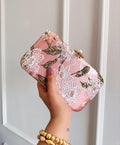 Blush pink embroidered box clutch with white and gold floral beadwork and a gold clasp