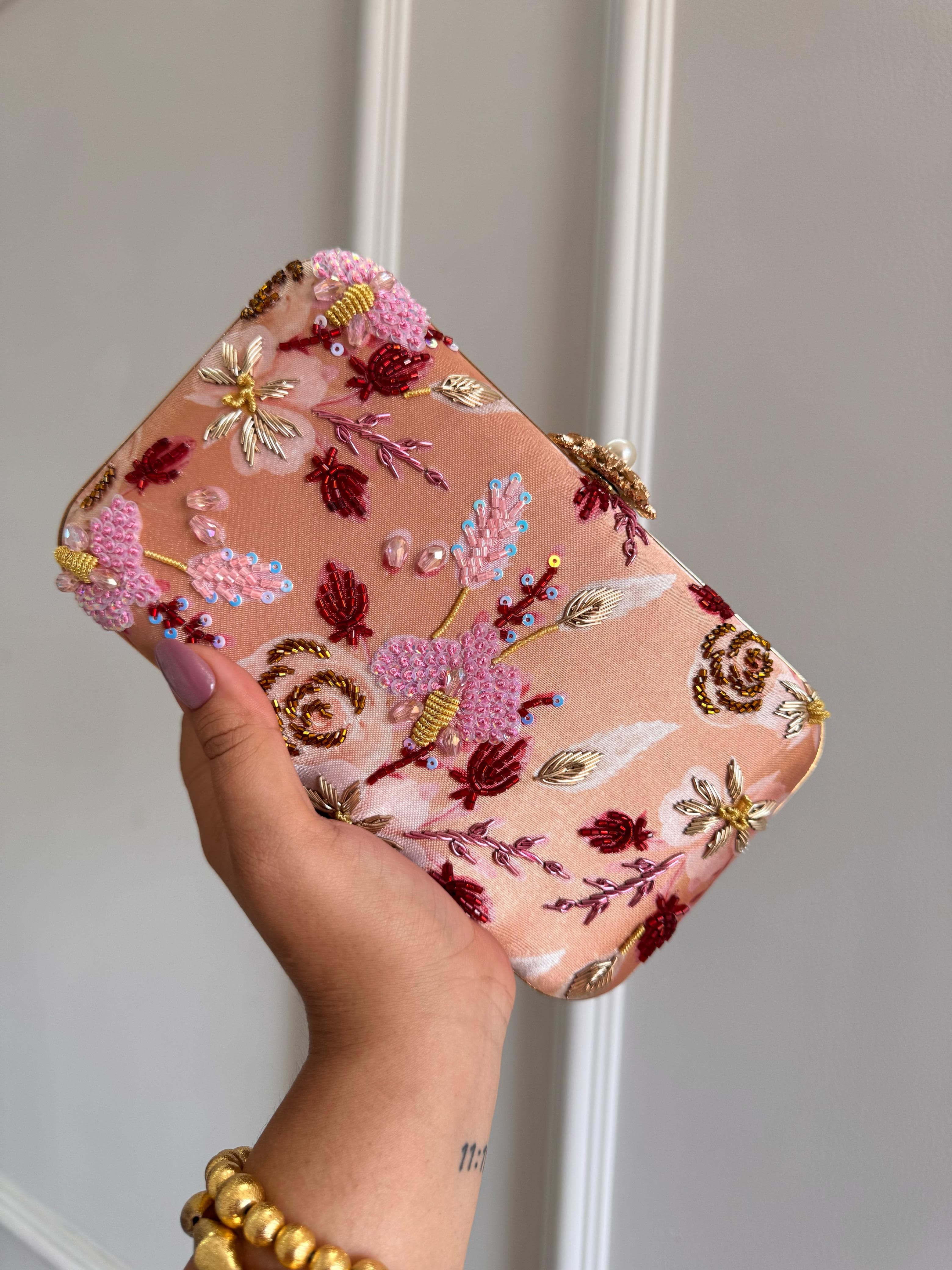 Peach multicolour embroidered box clutch with rose and gold zardozi beadwork and a gold clasp