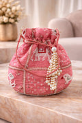 Potli bag in pink embroidered silk with pearl handle, ethnic wedding detail, three-quarter view