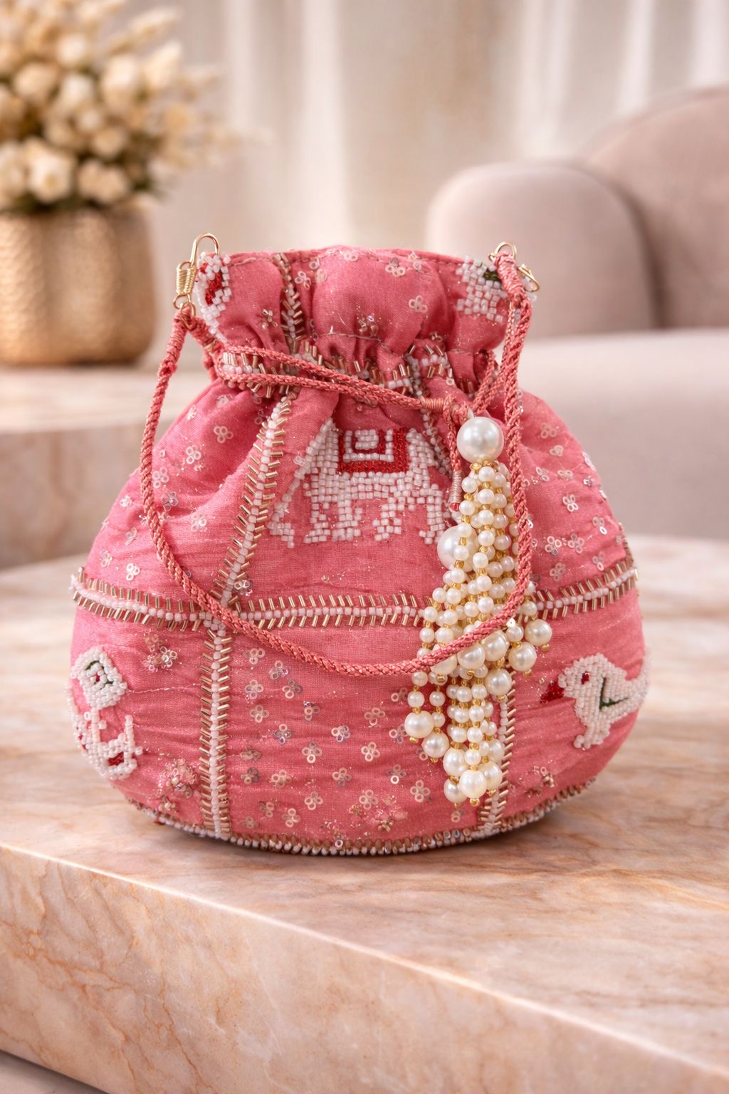 Potli bag in pink embroidered silk with pearl handle, ethnic wedding detail, three-quarter view