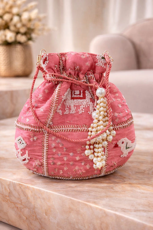Potli bag in pink embroidered silk with pearl handle, ethnic wedding detail, three-quarter view