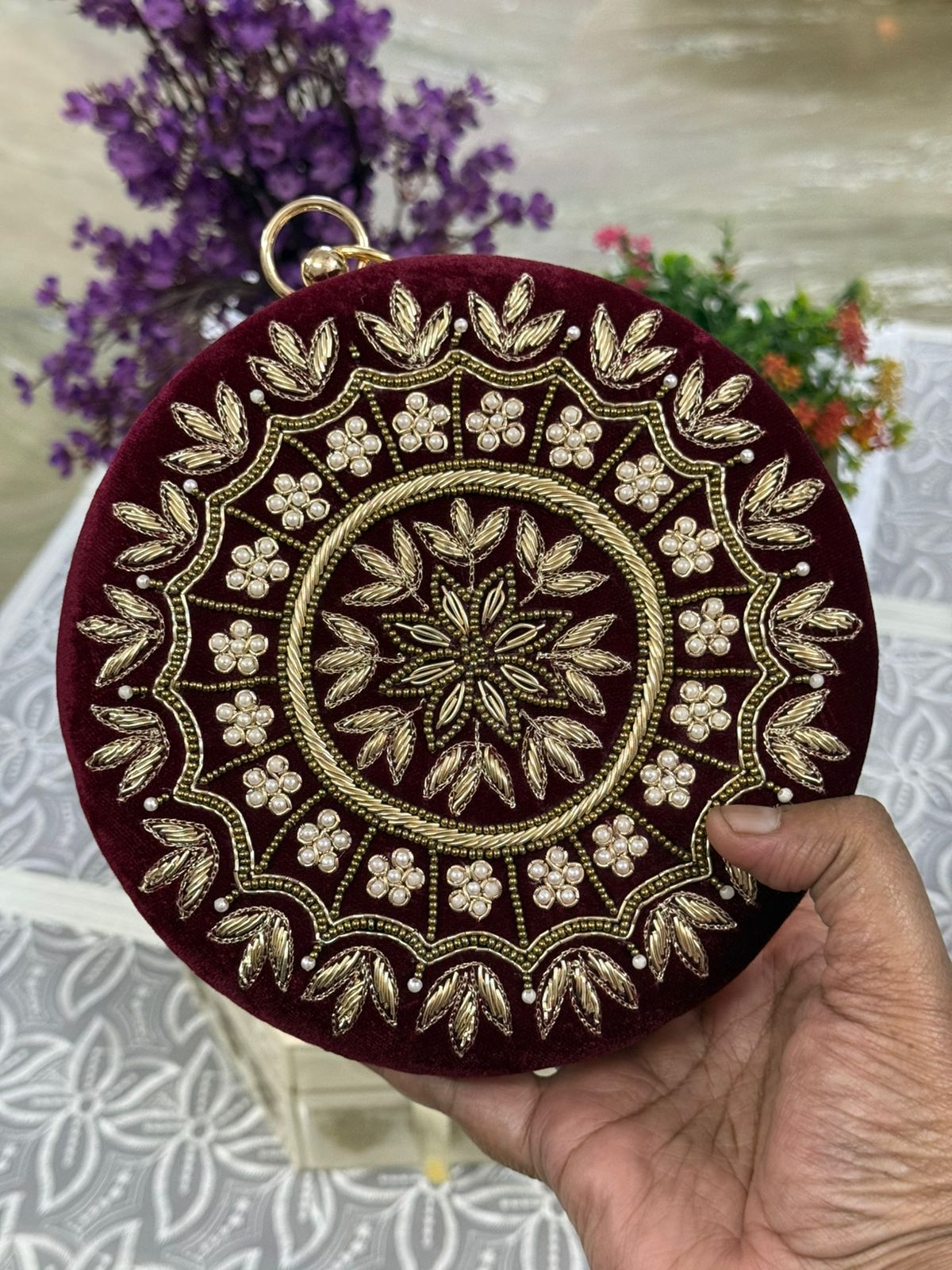 Maroon velvet round box clutch with gold zardozi and pearl mandala