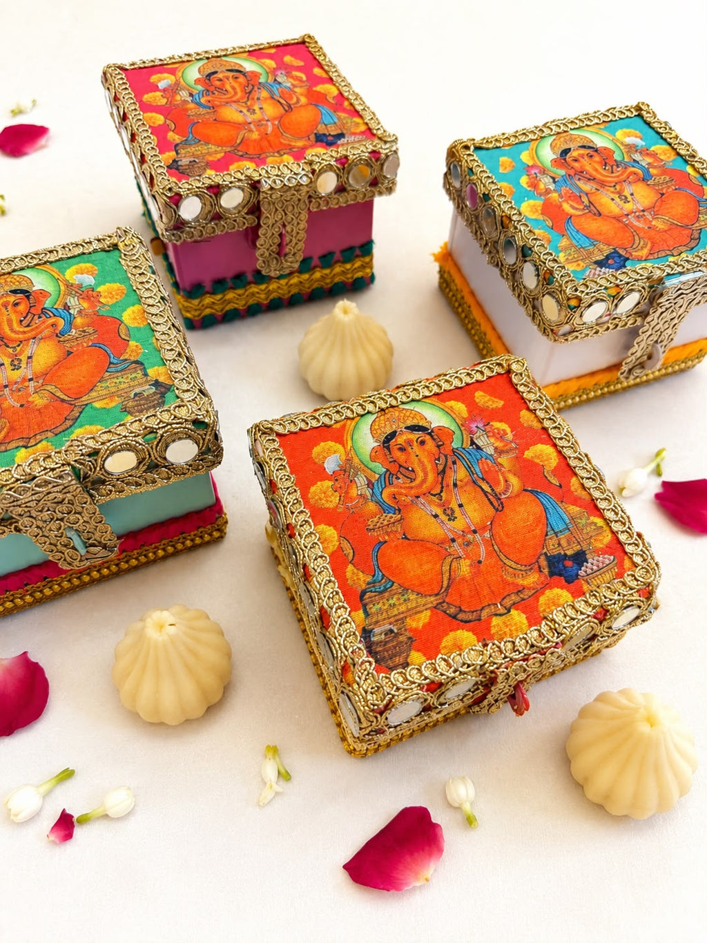 Ganesha modak trunk boxes in magenta, mint green, orange and white with mirror work borders, Sache bulk return gifts
