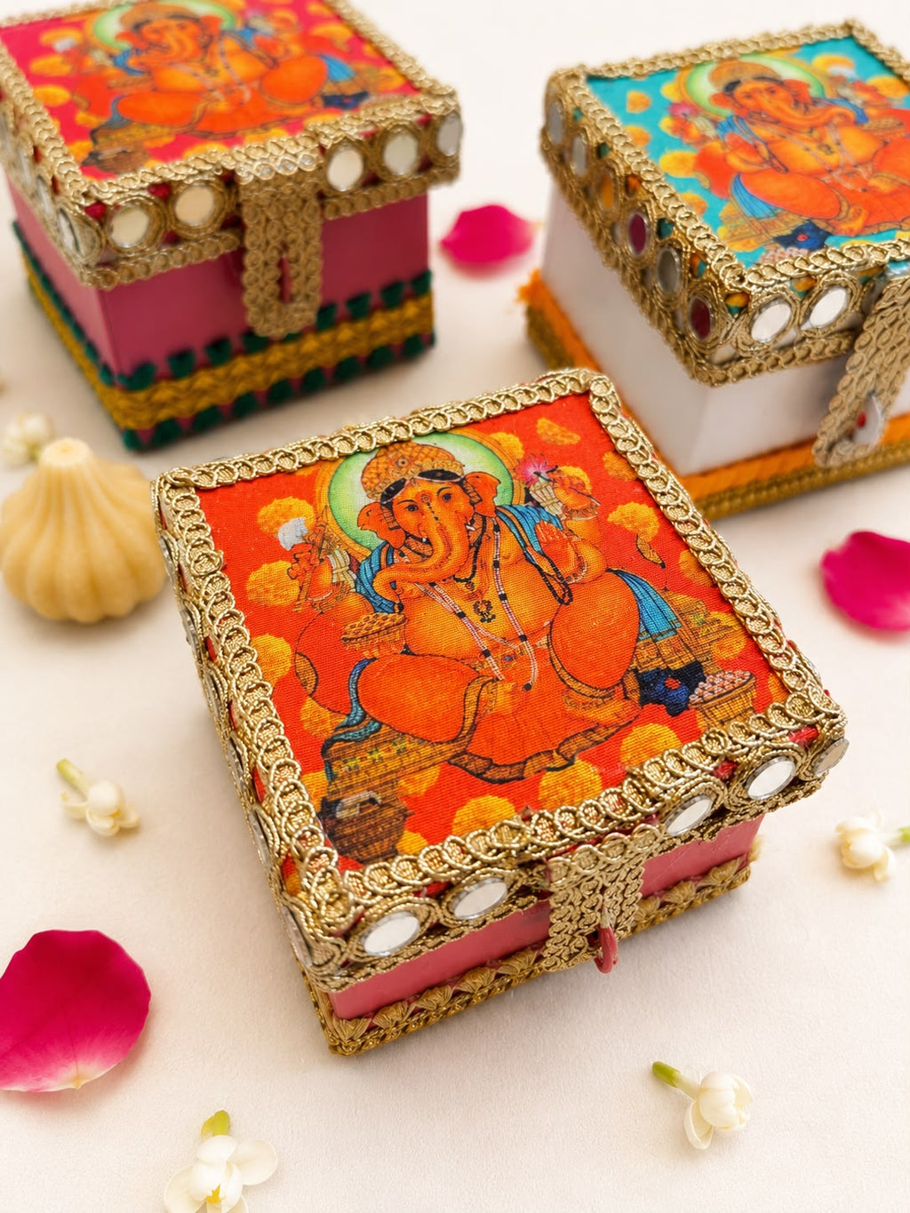 Orange Ganesha modak trunk box with gold gota lace, mirror shisha work and a front latch, a Sache Ganesh Chaturthi return gift