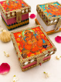 Orange Ganesha modak trunk box with gold gota lace, mirror shisha work and a front latch, a Sache Ganesh Chaturthi return gift