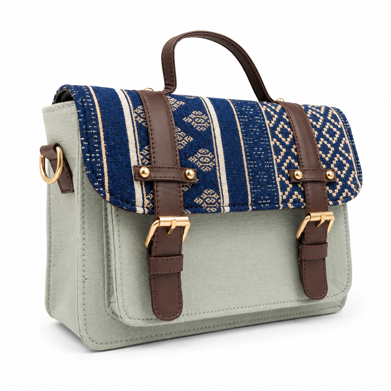 Sage green mini satchel with a handwoven indigo ikat flap, gold buckles and top handle, on a white background